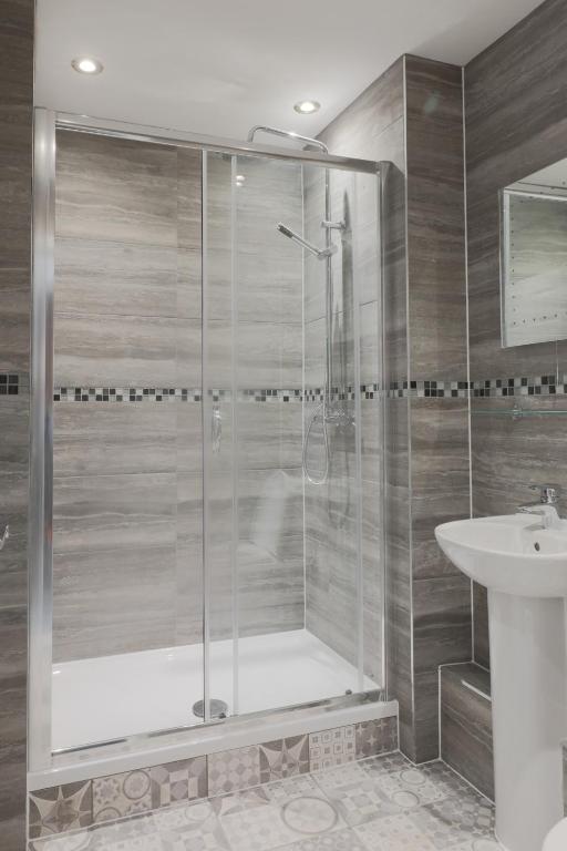 a bathroom with a shower and a sink at The Glebe Hotel in Liverpool