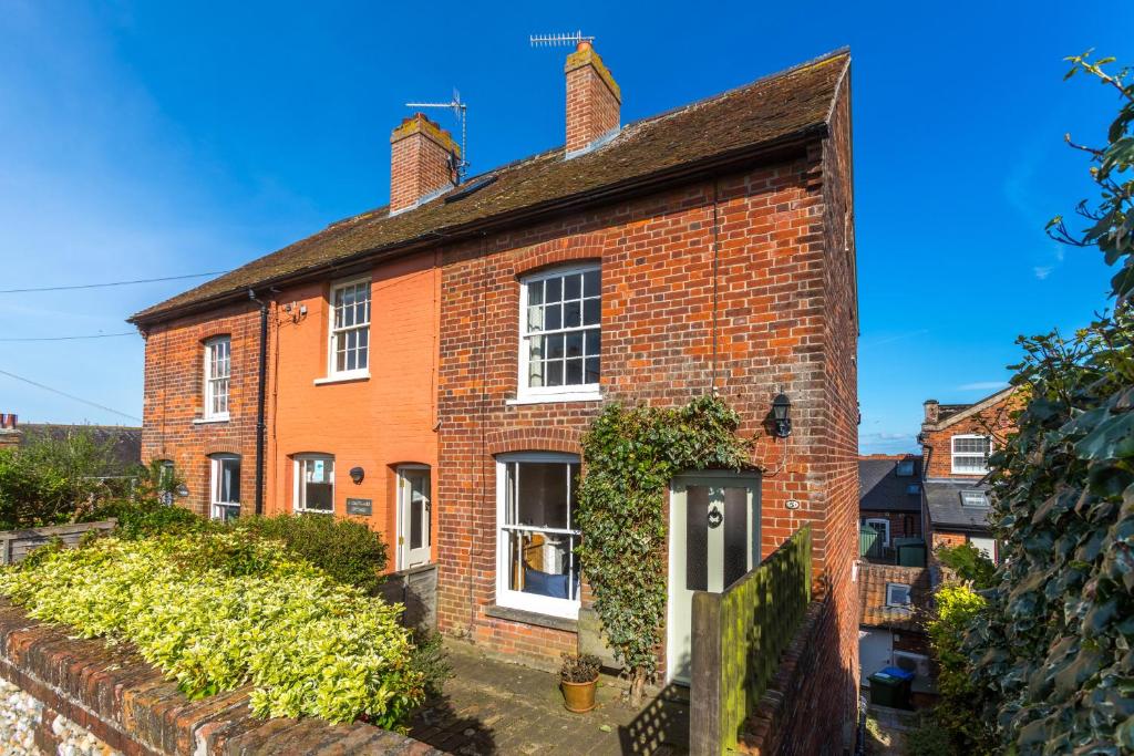 an old red brick house with white windows at 5 Coastguard Cottages in Aldeburgh