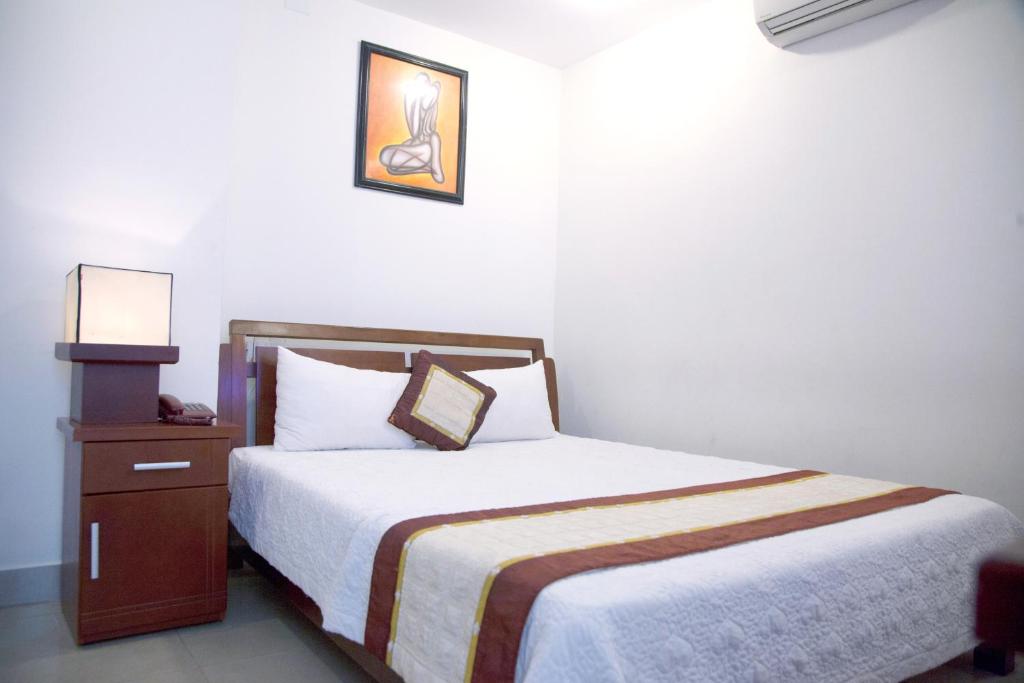 מיטה או מיטות בחדר ב-Hoang Thuy Sinh Hotel