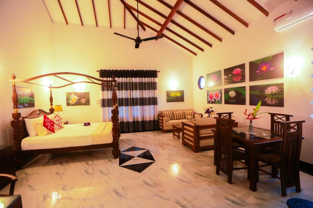 a living room with a bed and a table at SRI LANKAN VILLA in Galle