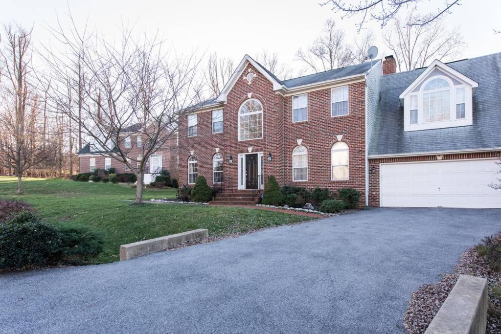 a red brick house with a white garage at Superb Basement close to the Gaylord MGM Outlets National Harbor in Fort Washington