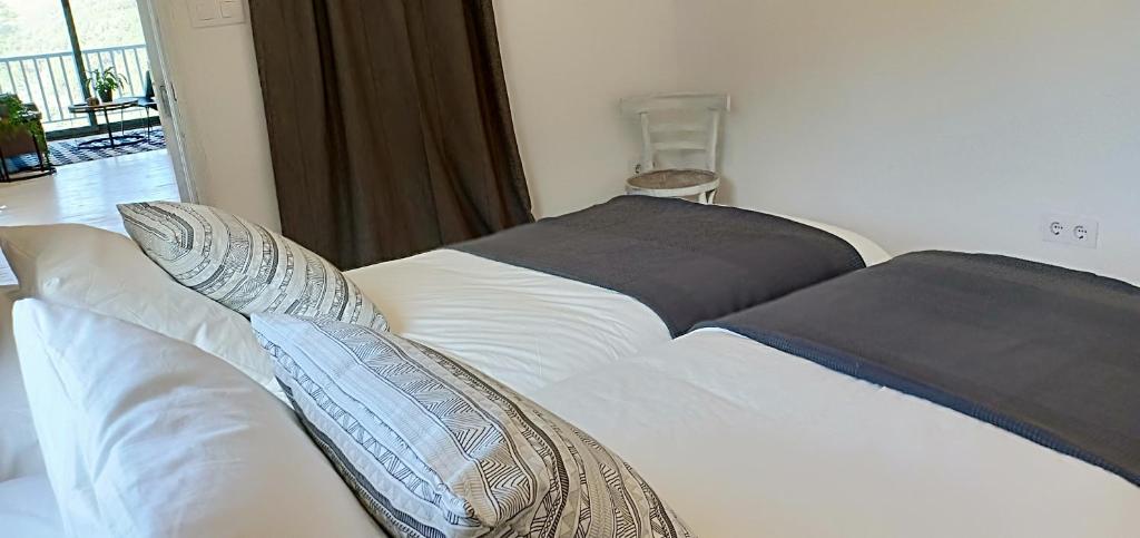 A bed or beds in a room at Casa da Viña - Ribeira Sacra