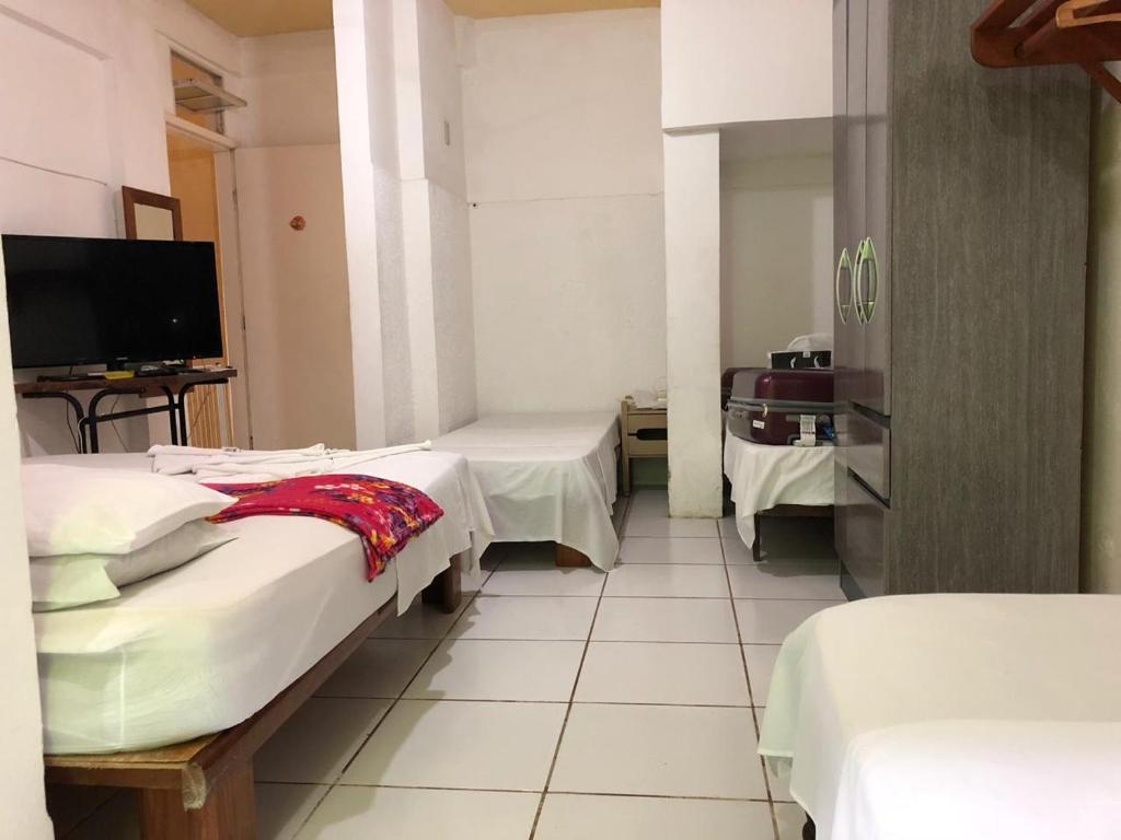 Uma cama ou camas num quarto em Pousada Caravelas
