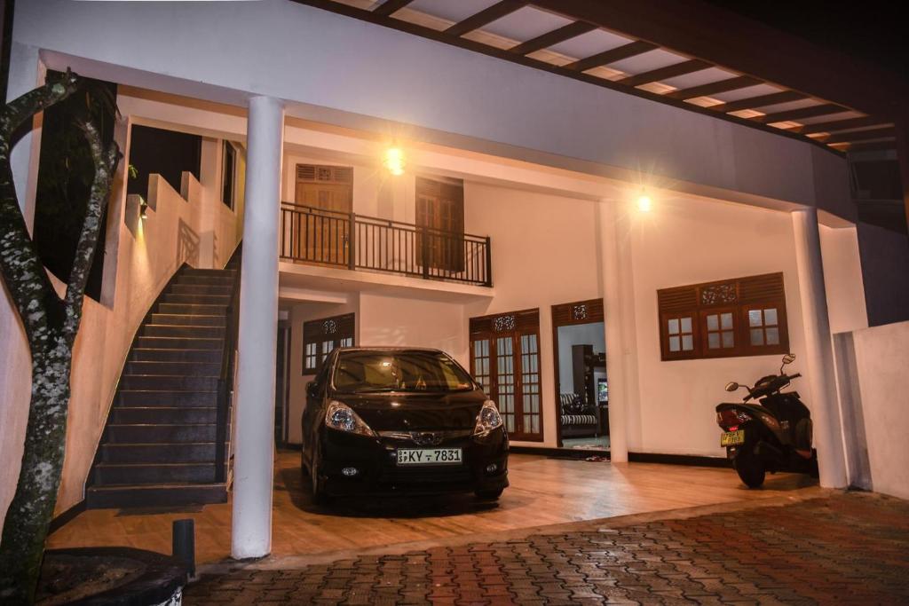 a car parked in front of a house at Richmond Hillside in Galle