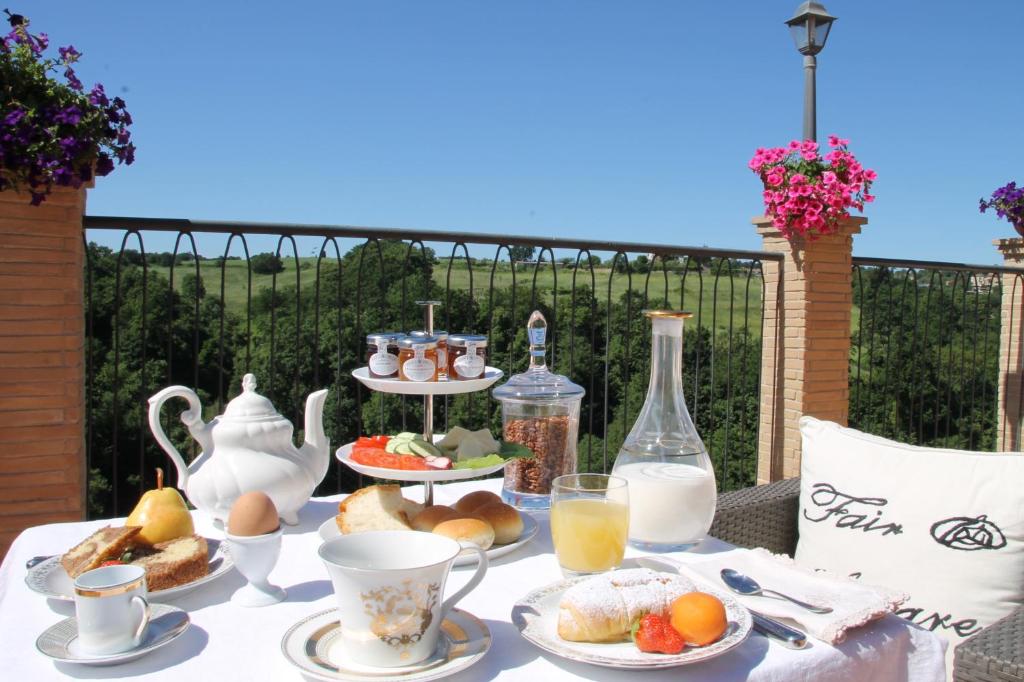 un tavolo con prodotti per la colazione e bevande di Hotel Tempio di Apollo a Olgiata