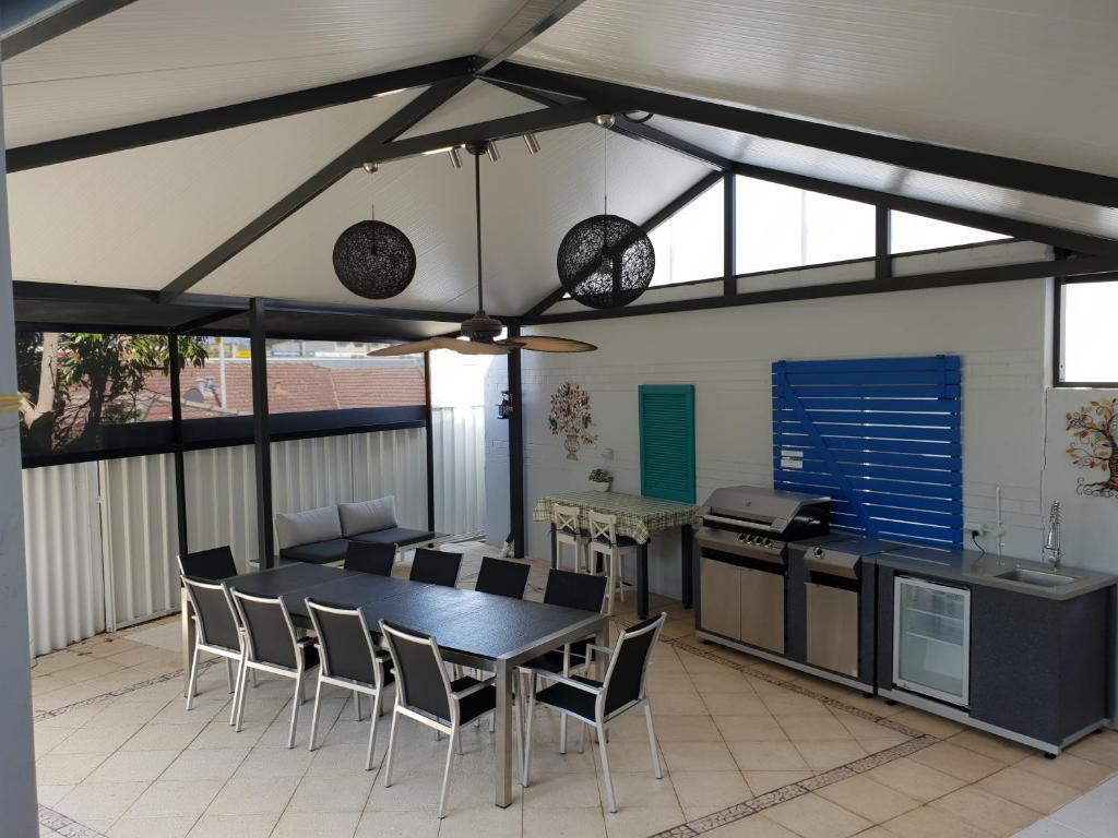 a kitchen and dining room with a table and chairs at Balcatta Sanctuary in Perth