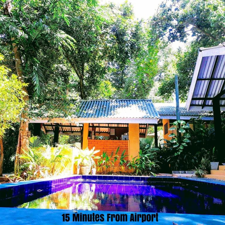 a house with a swimming pool in front of a house at Randoni Villa in Raddoluwa