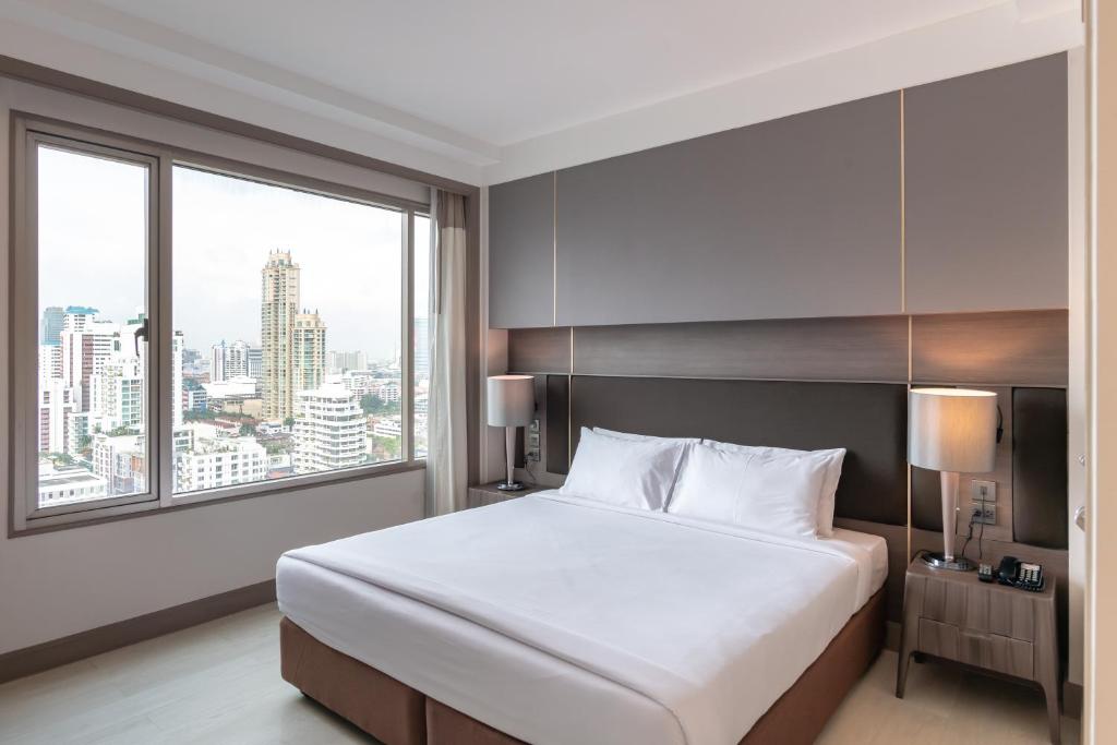 Postel nebo postele na pokoji v ubytování Jasmine City Hotel