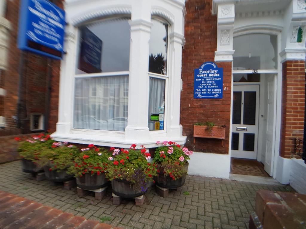 a row of flower pots in front of a building at Everley Guest House in Portsmouth