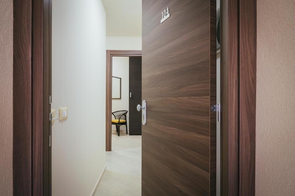 a wooden door in a room with a hallway at Hotel Costa Azul in Balestrate