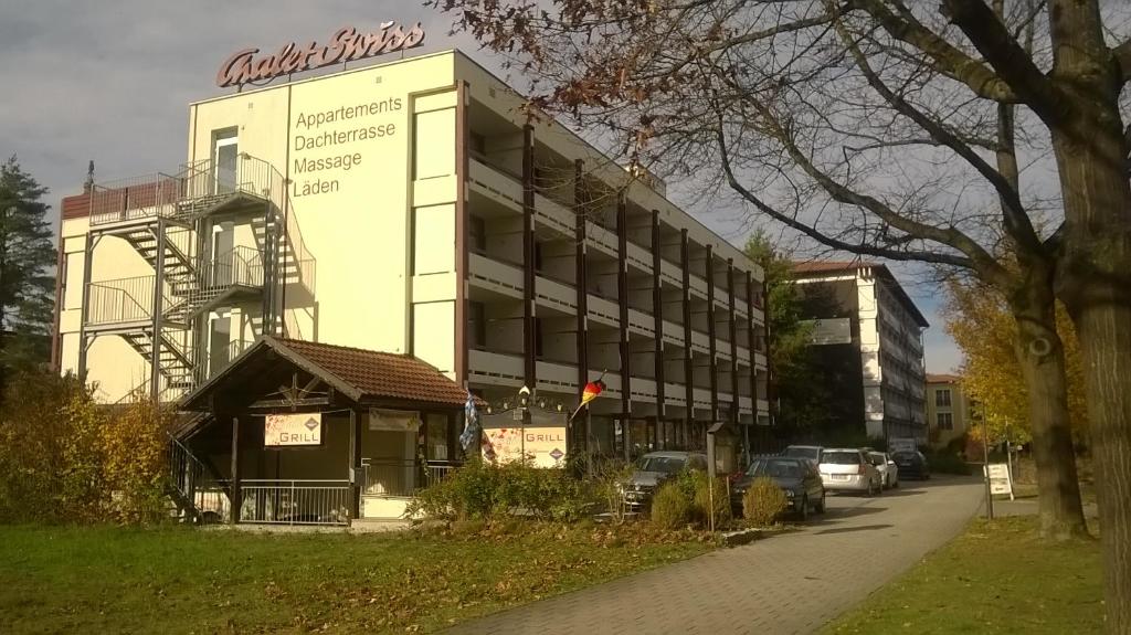 a building with a sign on the side of it at Chalet Swiss - App.Nelles in Bad Füssing