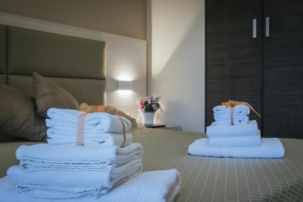 two stacks of towels sitting on top of a bed at Hotel Costa Azul in Balestrate