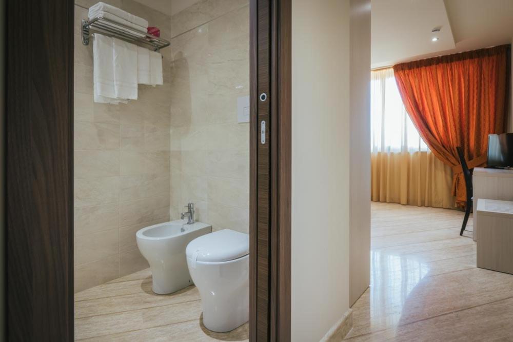 a bathroom with a toilet and a sink at Hotel Costa Azul in Balestrate