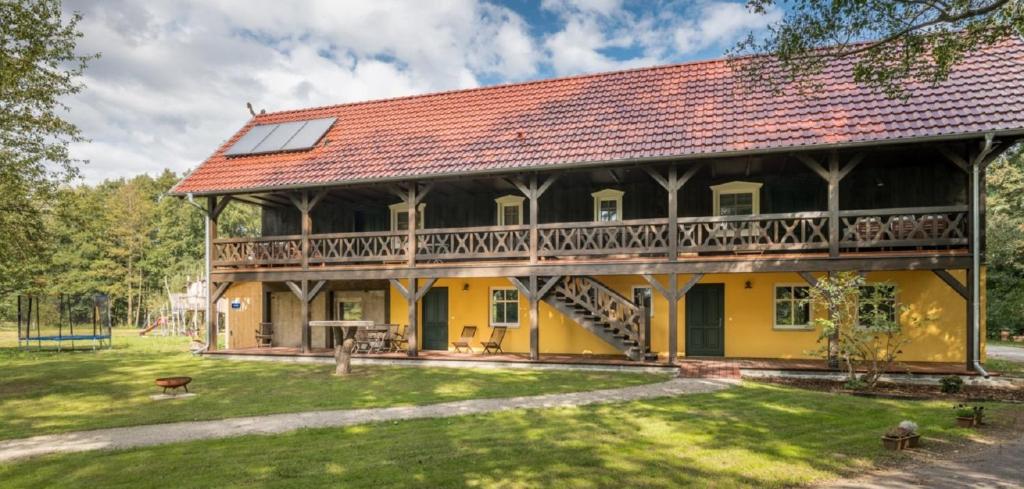 una gran casa amarilla con techo rojo en Adelinenhof - Ferienapartments, Fasten, Wellness & Gesundheit, en Burg