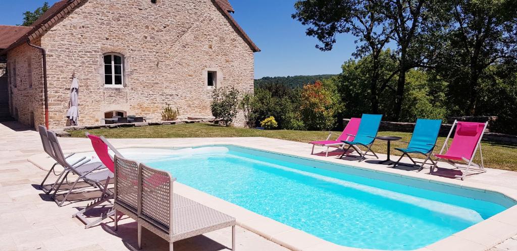 eine Gruppe Stühle und ein Pool in der Unterkunft La Tour Charlemagne in Château-Chalon