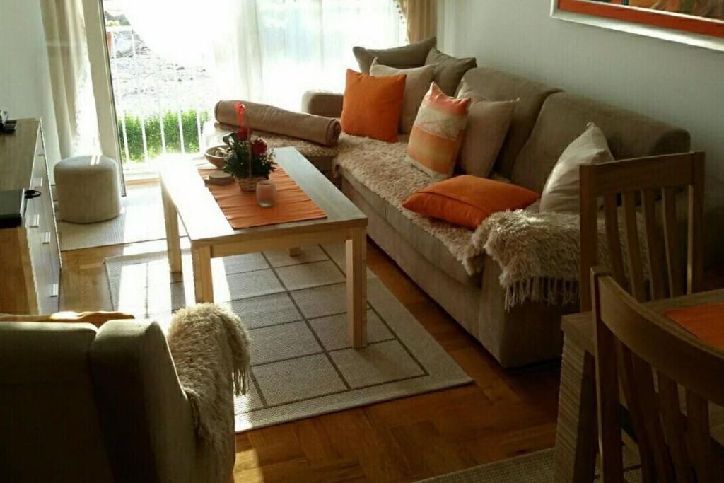 a living room with a couch and a table at Apartments Maljevic Maca in Bar