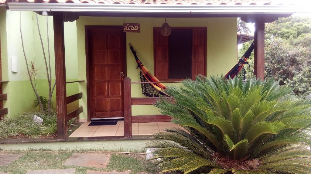 a house with a door and a porch with a plant at Pousada Licuri in Serra do Cipo