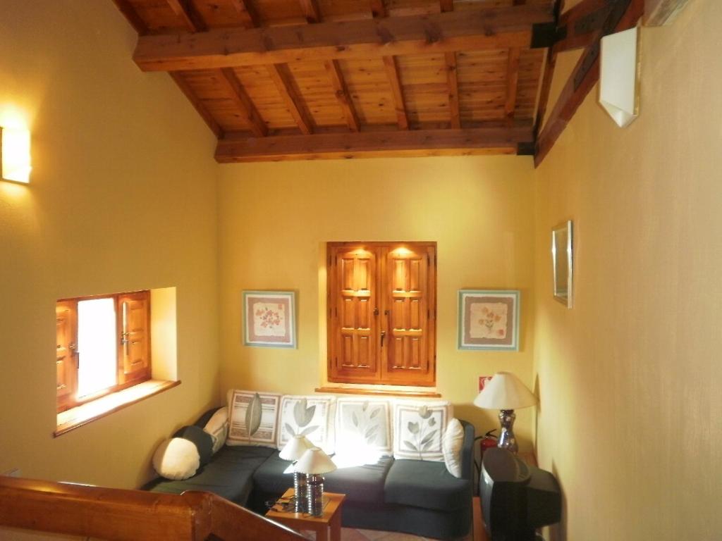 a living room with a couch and a window at Posada de Serrada in Serrada de la Fuente