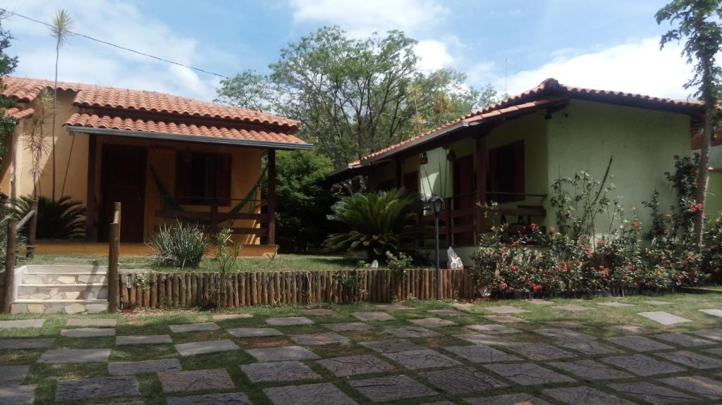 a house with a fence in front of it at Pousada Licuri in Serra do Cipo