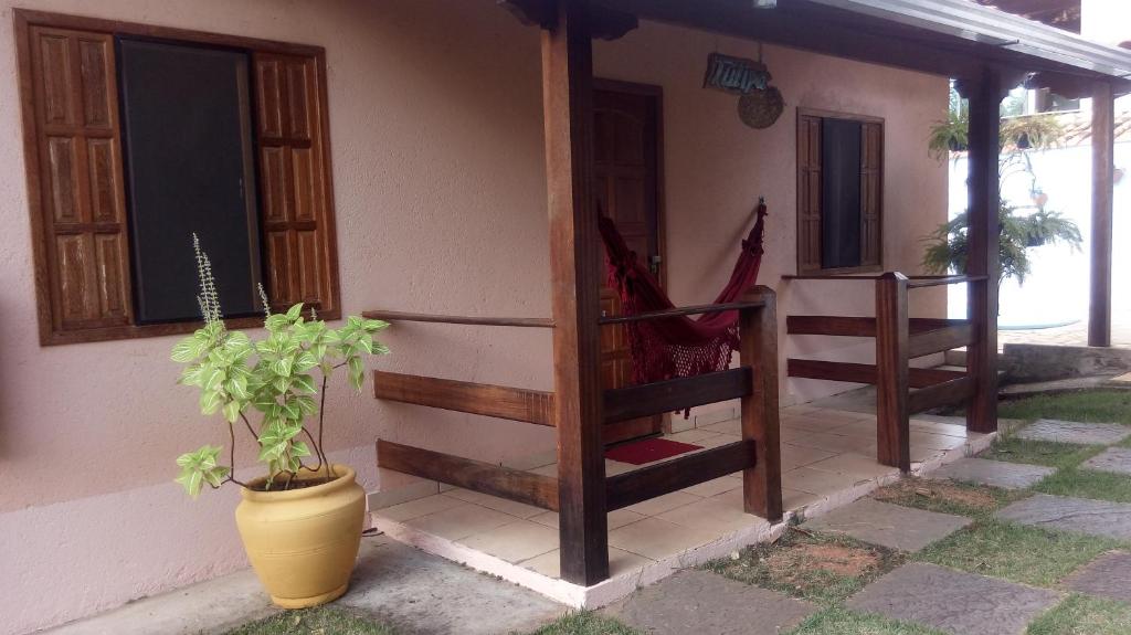 a porch of a house with a plant next to it at Pousada Licuri in Serra do Cipo