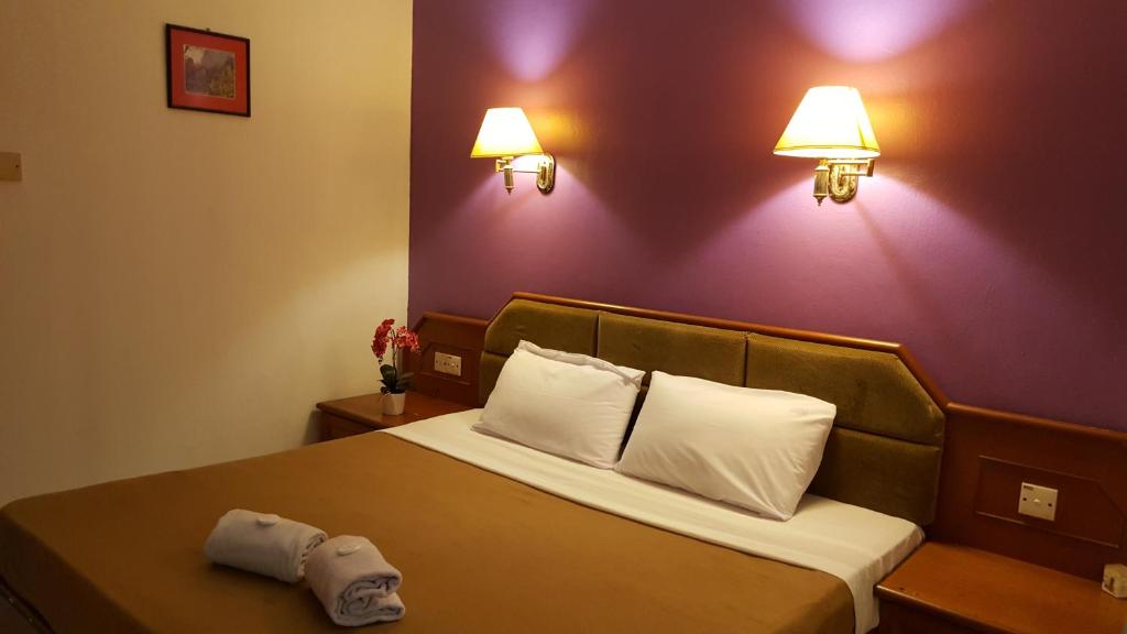 Postel nebo postele na pokoji v ubytování New Orchid Hotel Tuaran