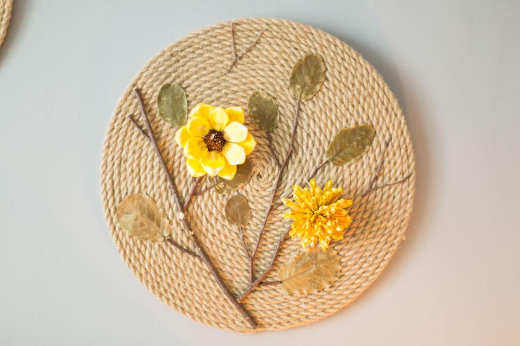 a straw hat with a yellow flower on it at Jinan Shizhong·Quancheng Square· Locals Apartment 00127290 in Jinan