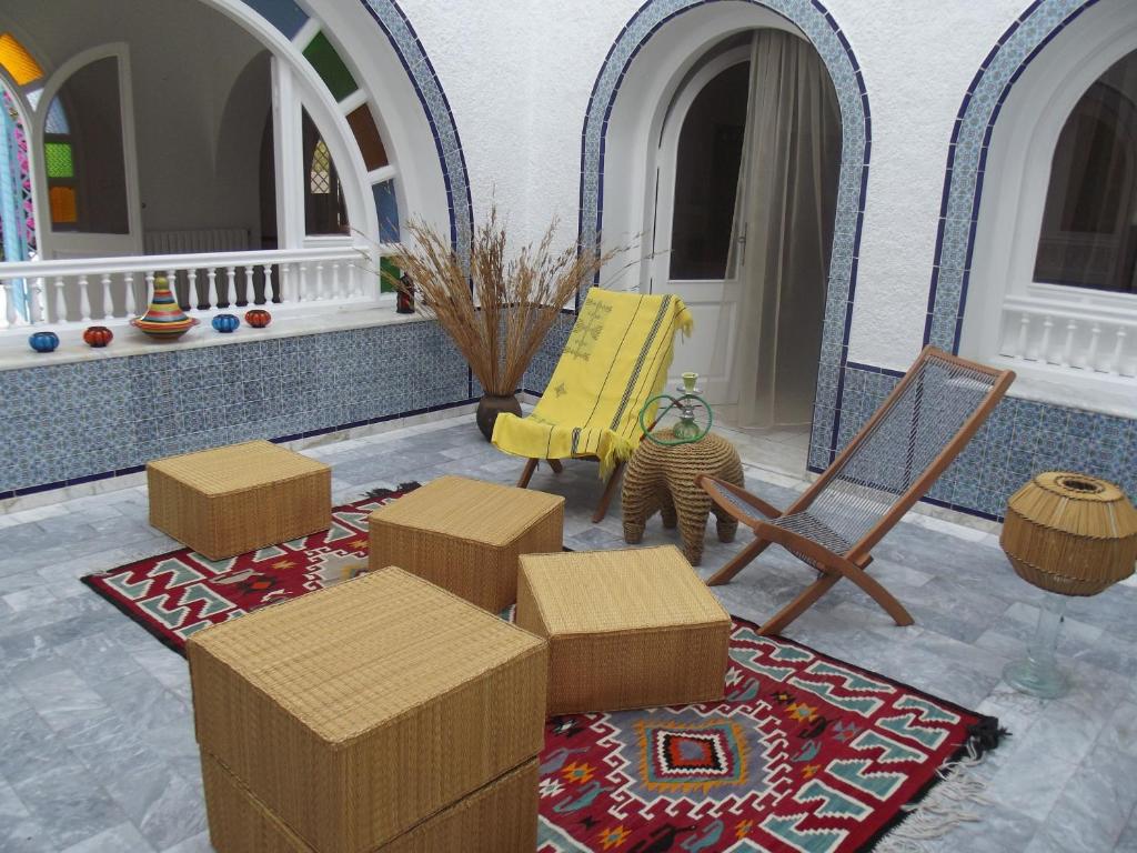 a living room with boxes and a yellow chair at Villa Phoenicia in Hammamet