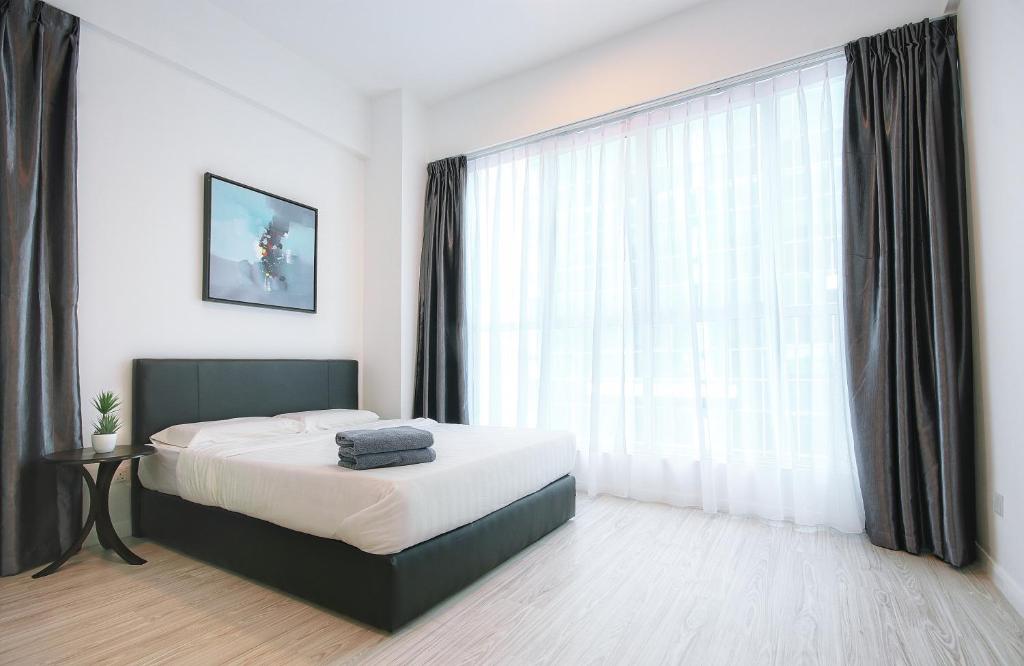 KEEN Suites@Sutera Avenueにあるベッド