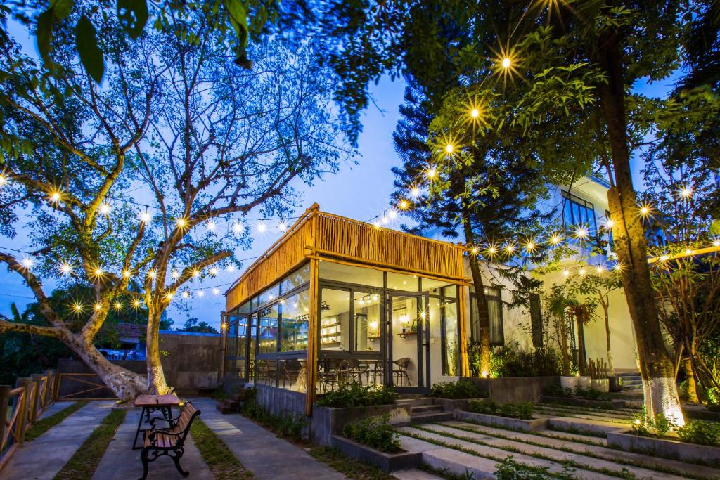 a house with christmas lights in front of it at La Paix Hue Riverside Villa in Hue