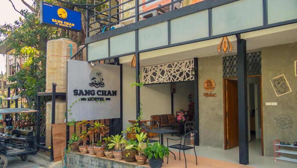 a building with a sign on the side of it at Sangchan hostel in Ko Lipe