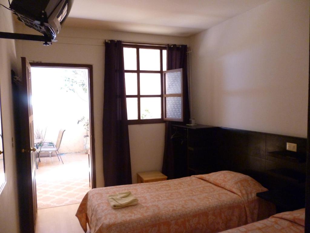 Postel nebo postele na pokoji v ubytování Hotel San Martin