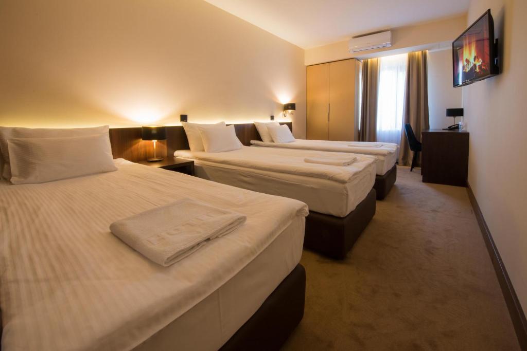 Postel nebo postele na pokoji v ubytování Hotel Spa Grad