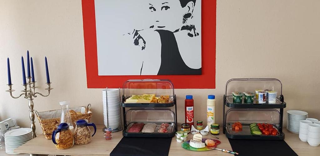 a table with two trays of food on it at Hotel Garni in Herborn