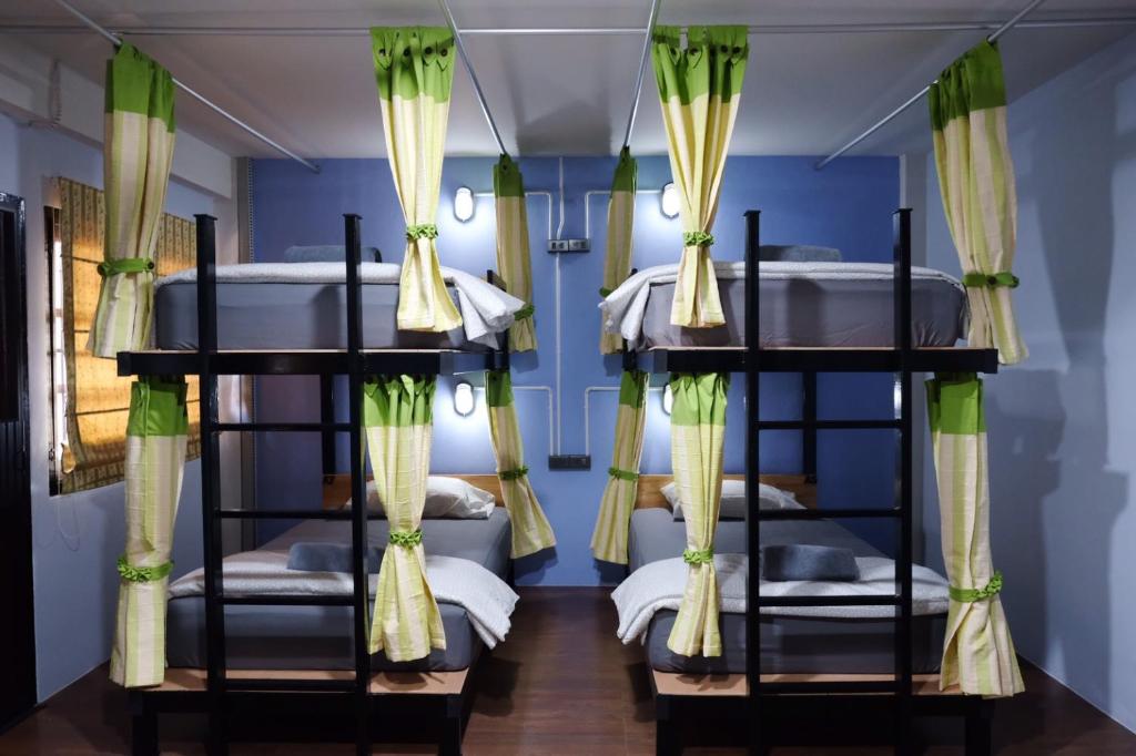 a room with bunk beds with blue walls at Tangmo House in Chiang Mai