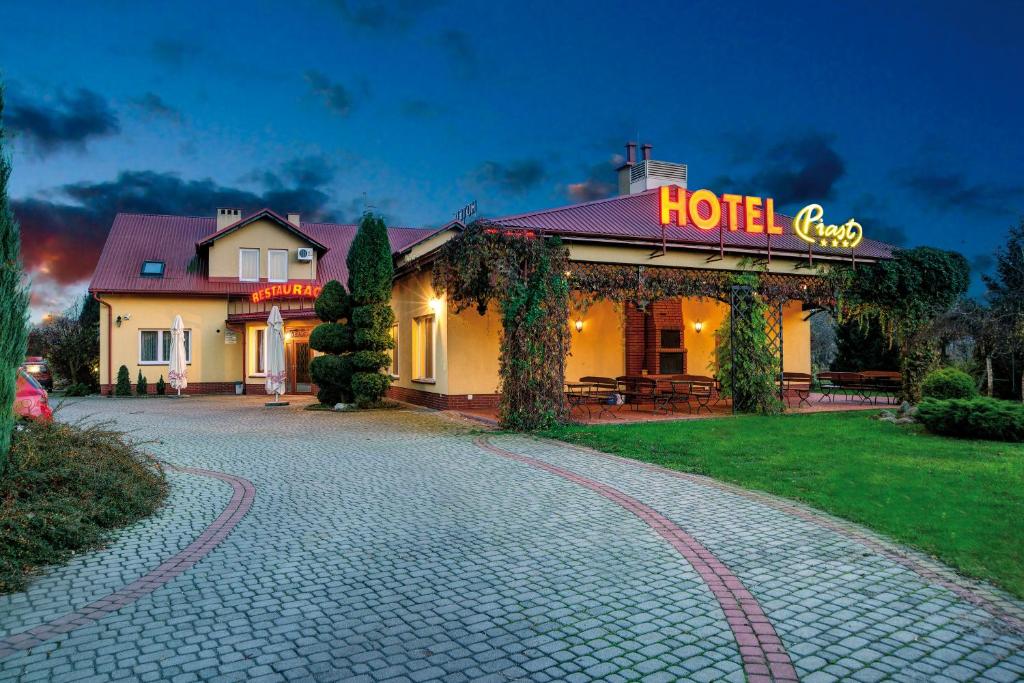 a hotel with a sign on the side of a building at Hotel "Piast" in Tuczempy