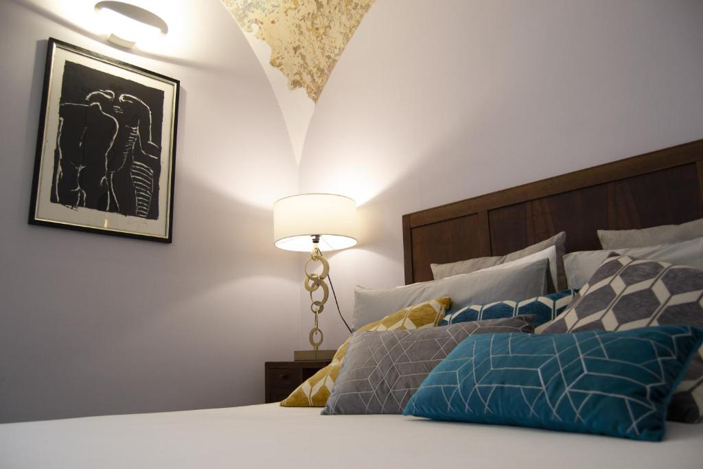 a bedroom with a bed with a lamp on it at Palazzo Stendardo in Cava deʼ Tirreni