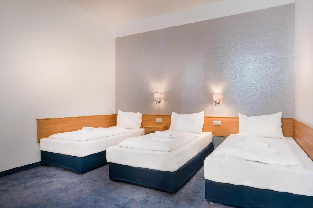 Postel nebo postele na pokoji v ubytování East City Budapest