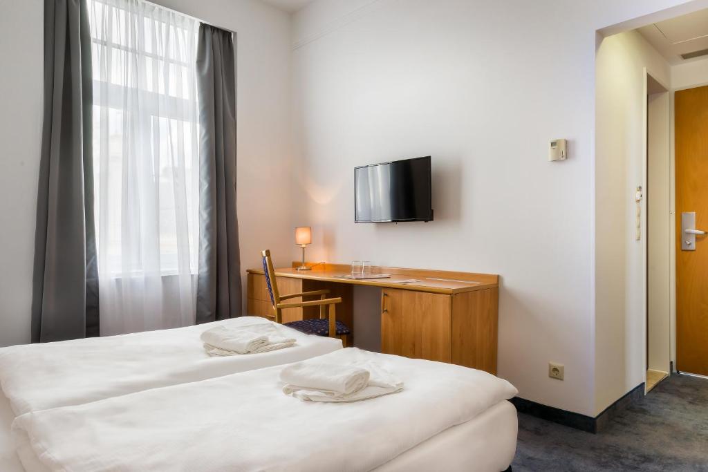 Postel nebo postele na pokoji v ubytování East City Budapest