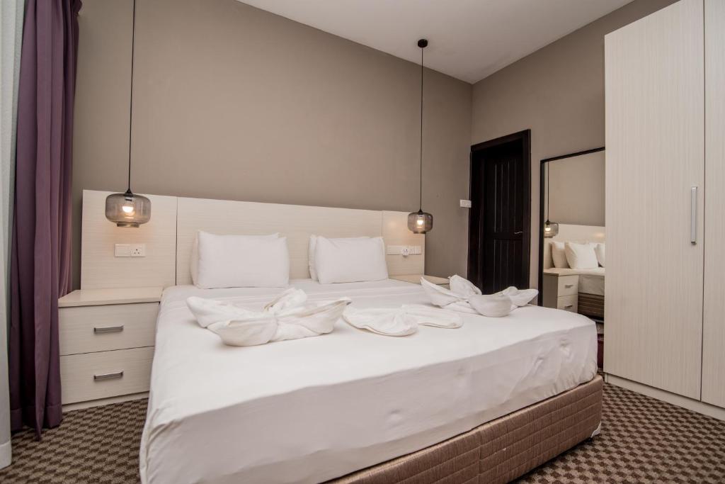 Postel nebo postele na pokoji v ubytování W Residence Kandy