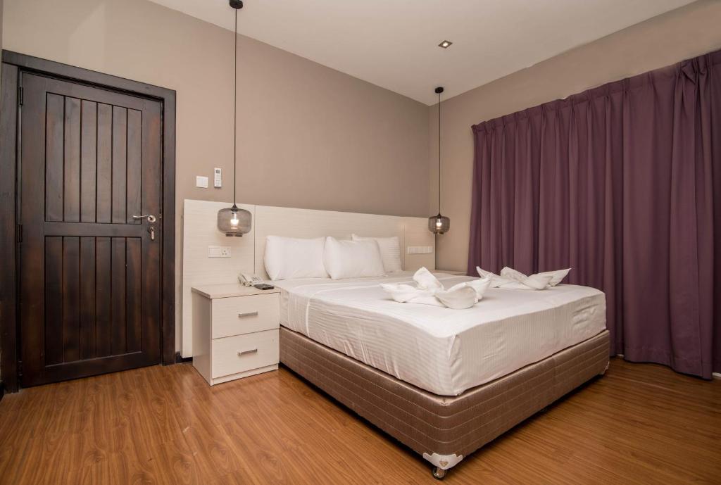 Postel nebo postele na pokoji v ubytování W Residence Kandy
