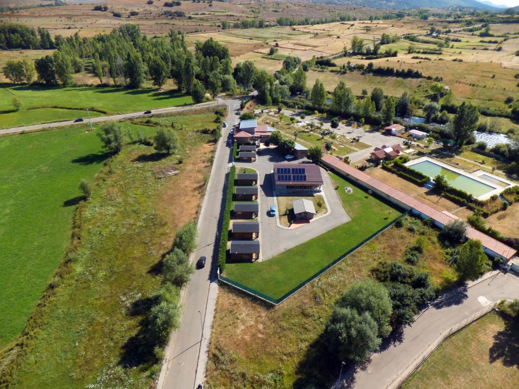 an aerial view of a farm with a building at Las Cabañas in Vegaquemada