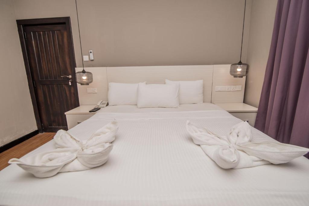 Postel nebo postele na pokoji v ubytování W Residence Kandy