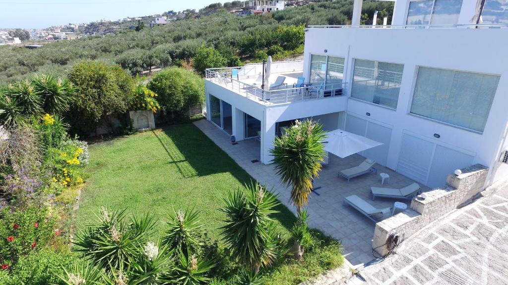 an aerial view of a house with a yard at WhiteBlue Spa Villa, By IdealStay Experience in Heraklio