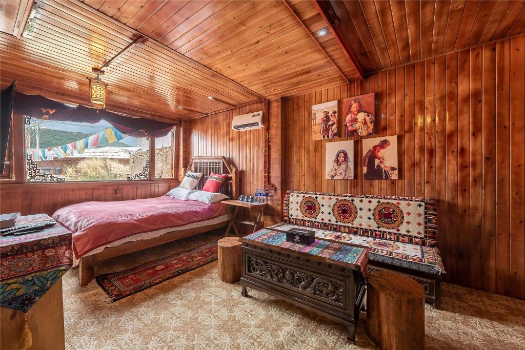 a bedroom with a bed in a wooden room at Yi's Hostel in Shangri-La