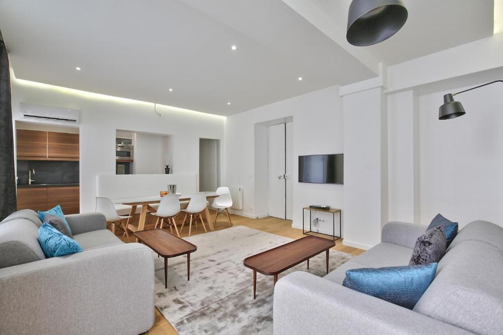 a living room with two couches and a table at 69 - Authentic Parisian Home in Paris