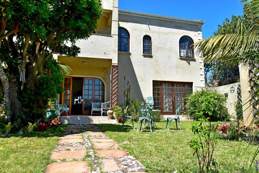 a house with a pathway leading to the front yard at Sea Valley Villa in Port Alfred
