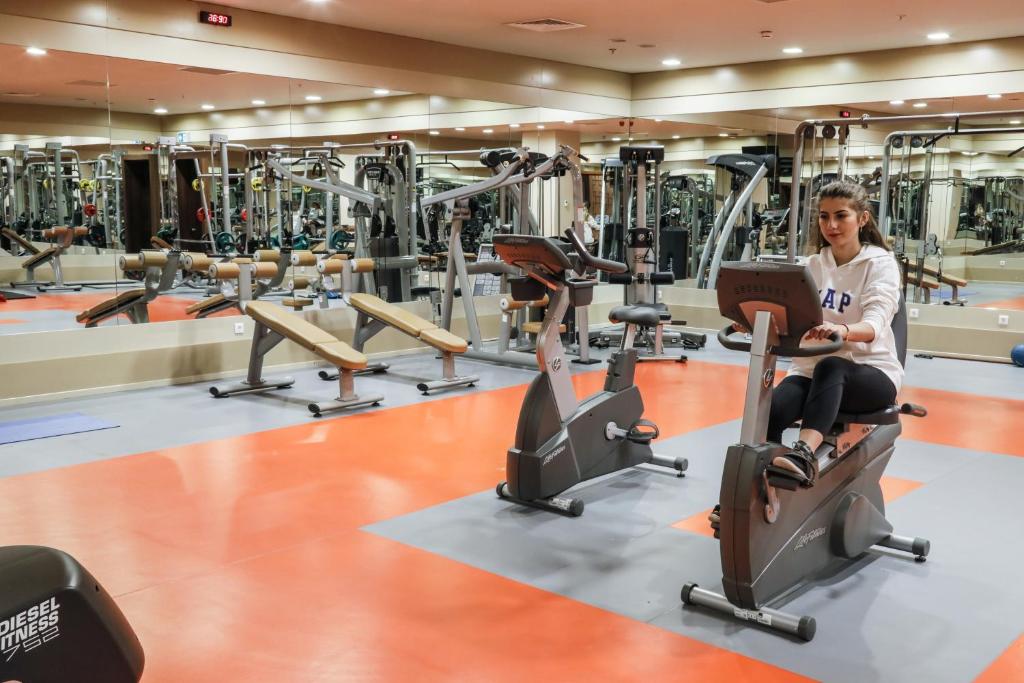 a woman exercising in a gym at ISG Sabiha Gökçen Airport Hotel in Istanbul