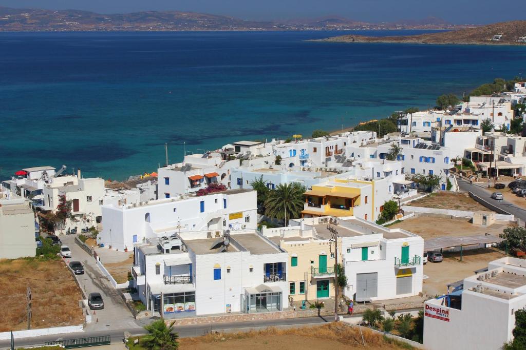 an aerial view of a town with white buildings and the ocean at Aspasia Luxury Apartments in Agia Anna Naxos