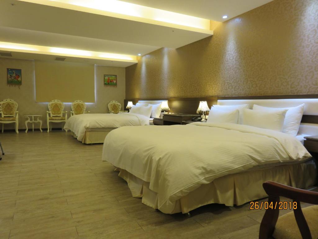 Postel nebo postele na pokoji v ubytování Mao Hua Motel