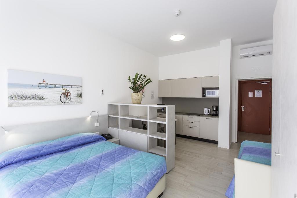 Кровать или кровати в номере Residenza Turistica Alberghiera Blue Marine